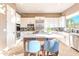 Bright kitchen with white cabinetry, stainless steel appliances, and center island with seating at 10772 E Running Deer Trl, Scottsdale, AZ 85262