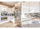 Bright kitchen with white cabinetry, stainless steel appliances, and mosaic tile backsplash at 10772 E Running Deer Trl, Scottsdale, AZ 85262