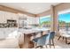 Bright kitchen with white cabinetry, stainless steel appliances, and center island with seating at 10772 E Running Deer Trl, Scottsdale, AZ 85262