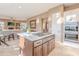 Bright kitchen with large island cooktop, stainless ovens, and bar seating area at 10772 E Running Deer Trl, Scottsdale, AZ 85262