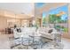 Spacious living area with high ceilings, large windows offering outdoor views, and comfortable seating at 10772 E Running Deer Trl, Scottsdale, AZ 85262