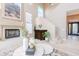 Inviting living space showcasing a fireplace, staircase, and elegant decor at 10772 E Running Deer Trl, Scottsdale, AZ 85262