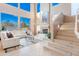 Bright and airy living room featuring a fireplace, large windows, and modern decor at 10772 E Running Deer Trl, Scottsdale, AZ 85262