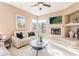 Cozy living room with fireplace, plush seating, and decorative accents at 10772 E Running Deer Trl, Scottsdale, AZ 85262