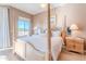 Serene main bedroom featuring a four-poster bed, views, and bedside tables at 10772 E Running Deer Trl, Scottsdale, AZ 85262