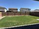 Expansive backyard featuring a lush lawn and a block fence for privacy at 10956 E Thunderbolt Ave, Mesa, AZ 85212