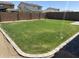 Spacious backyard featuring a well-maintained lawn with stone-edged landscaping at 10956 E Thunderbolt Ave, Mesa, AZ 85212