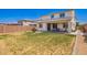 Spacious backyard featuring a covered patio perfect for entertaining, with lush grass at 10956 E Thunderbolt Ave, Mesa, AZ 85212