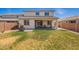 Large backyard featuring a covered patio, comfortable seating, and a well-manicured lawn at 10956 E Thunderbolt Ave, Mesa, AZ 85212