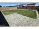 Large backyard with patio and lush green lawn and brick fence at 10956 E Thunderbolt Ave, Mesa, AZ 85212