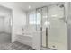 Bright bathroom featuring a glass shower, soaking tub, and decorative tile flooring at 10956 E Thunderbolt Ave, Mesa, AZ 85212