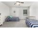 Shared bedroom with a ceiling fan and natural light at 10956 E Thunderbolt Ave, Mesa, AZ 85212