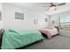 Shared bedroom featuring two beds with a ceiling fan and natural light at 10956 E Thunderbolt Ave, Mesa, AZ 85212