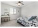 Cozy bedroom with a ceiling fan, and a comfortable bed with floral bedding at 10956 E Thunderbolt Ave, Mesa, AZ 85212
