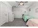 Shared bedroom featuring two beds, a ceiling fan, and a dresser at 10956 E Thunderbolt Ave, Mesa, AZ 85212