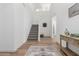 Spacious entryway featuring a staircase, hardwood floors, a decorative rug, and a charming console table at 10956 E Thunderbolt Ave, Mesa, AZ 85212