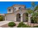 Two-story stucco home with a two-car garage, desert landscaping, and covered front porch at 10956 E Thunderbolt Ave, Mesa, AZ 85212