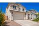 Lovely two-story home with a two car garage, manicured yard and welcoming front porch with arched entry at 10956 E Thunderbolt Ave, Mesa, AZ 85212