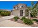 Charming two-story home featuring a two-car garage, landscaped front yard and welcoming front porch with arched entryway at 10956 E Thunderbolt Ave, Mesa, AZ 85212