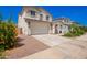 Two-story home with a neutral stucco finish, attached two-car garage, and desert-friendly landscaping at 10956 E Thunderbolt Ave, Mesa, AZ 85212