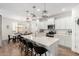 Bright open kitchen with large island, stainless appliances, modern pendant lights, table and chairs at 10956 E Thunderbolt Ave, Mesa, AZ 85212
