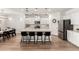 Bright, open-concept kitchen with large island, seating, modern lighting, and stainless steel appliances at 10956 E Thunderbolt Ave, Mesa, AZ 85212