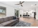 Open concept living room featuring hardwood floors, neutral furniture, and a seamless flow into the kitchen at 10956 E Thunderbolt Ave, Mesa, AZ 85212