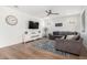 Bright living room featuring hardwood floors, a ceiling fan, recessed lighting, and a comfortable gray sofa at 10956 E Thunderbolt Ave, Mesa, AZ 85212