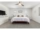 Calm main bedroom with neutral colors, a ceiling fan, and large windows, offering a serene retreat at 10956 E Thunderbolt Ave, Mesa, AZ 85212
