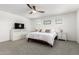 Spacious main bedroom with ceiling fan, carpet, and ample windows allowing for plenty of natural light at 10956 E Thunderbolt Ave, Mesa, AZ 85212