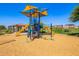 Community playground with multiple slides and play areas under sunshades, set on a wood chip base at 10956 E Thunderbolt Ave, Mesa, AZ 85212