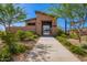 Community pool entrance featuring well-maintained landscaping, seating, and secure access gate at 10956 E Thunderbolt Ave, Mesa, AZ 85212