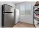 Convenient storage room equipped with a refrigerator, freezer, and ample shelving at 10956 E Thunderbolt Ave, Mesa, AZ 85212