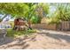 Backyard featuring mature trees and a play structure with a slide and swing at 1110 W Heatherbrae Dr, Phoenix, AZ 85013