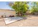 Backyard with concrete pad, play structure, trees, and gravel at 1110 W Heatherbrae Dr, Phoenix, AZ 85013