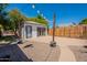 Detached bonus room with backyard featuring stone landscaping and a wooden privacy fence at 1110 W Heatherbrae Dr, Phoenix, AZ 85013