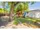 Backyard featuring mature trees, a play structure with a slide, and a grassy area at 1110 W Heatherbrae Dr, Phoenix, AZ 85013