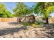 Backyard featuring a play structure, mature trees and a freshly poured concrete pad at 1110 W Heatherbrae Dr, Phoenix, AZ 85013