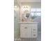 Bathroom featuring a marble vanity, round mirror, and classic black and white tile flooring at 1110 W Heatherbrae Dr, Phoenix, AZ 85013