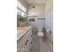 Well-lit bathroom featuring classic black-and-white tile, marble top vanity, and modern toilet at 1110 W Heatherbrae Dr, Phoenix, AZ 85013