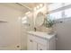 Clean bathroom featuring white vanity with marble top, tiled shower, and a sleek glass door at 1110 W Heatherbrae Dr, Phoenix, AZ 85013