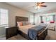 Cozy bedroom with a ceiling fan, nightstands, windows, and a comfortable seating area at 1110 W Heatherbrae Dr, Phoenix, AZ 85013