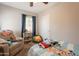 A bedroom with a twin bed, a comfortable armchair, and great storage at 1110 W Heatherbrae Dr, Phoenix, AZ 85013