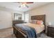 Bedroom featuring a ceiling fan, dresser, and comfortable bed with decorative pillows and blanket at 1110 W Heatherbrae Dr, Phoenix, AZ 85013