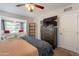 Well-lit bedroom boasts a ceiling fan, bay window, a dresser, and a cozy reading nook at 1110 W Heatherbrae Dr, Phoenix, AZ 85013