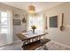Bright dining area with farmhouse style table and bench seating at 1110 W Heatherbrae Dr, Phoenix, AZ 85013