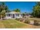Home exterior with mature landscaping, and a well-maintained lawn at 1110 W Heatherbrae Dr, Phoenix, AZ 85013
