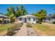 Charming home with mature landscaping, walkway, green lawn, and an inviting facade at 1110 W Heatherbrae Dr, Phoenix, AZ 85013