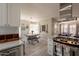 Eat-in kitchen showcases stainless steel appliances, white cabinets, a wood dining table, and wood floors at 1110 W Heatherbrae Dr, Phoenix, AZ 85013