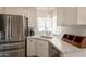 Bright kitchen features white cabinets, stainless steel appliances and a sink with marble countertop at 1110 W Heatherbrae Dr, Phoenix, AZ 85013